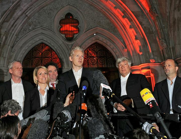 Julian Assange speaks to the press outside a central London court building after his release on bail