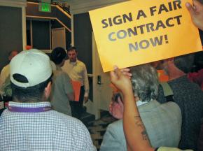 A manager at the Hotel Frank (in the white shirt) faces a protest by supporters of hotel workers
